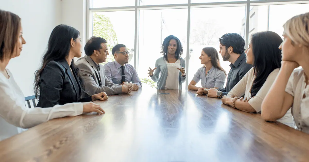 Diverse team having a meeting around conference table.