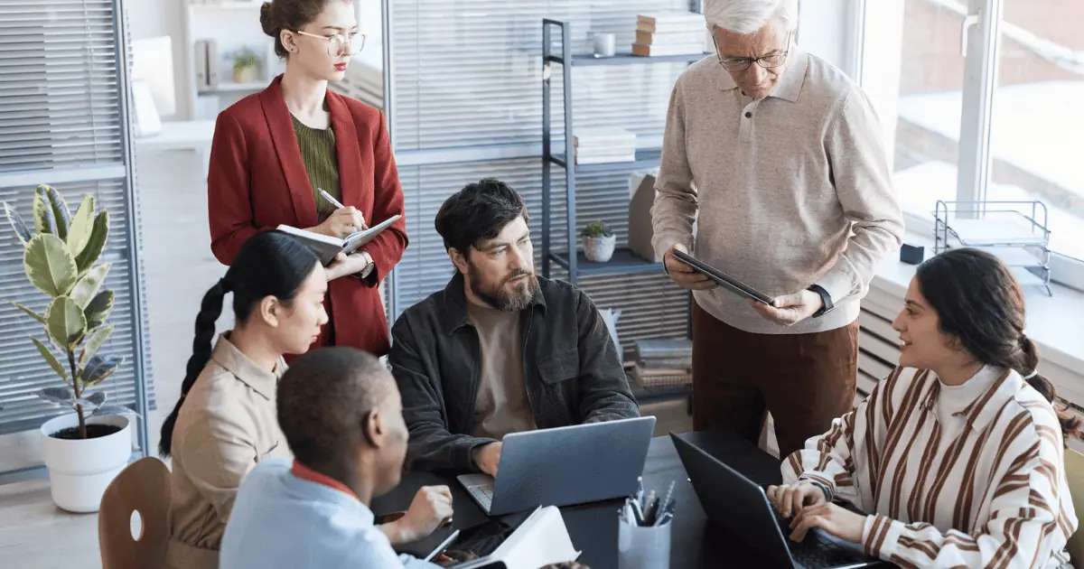Diverse team collaborating at office meeting table